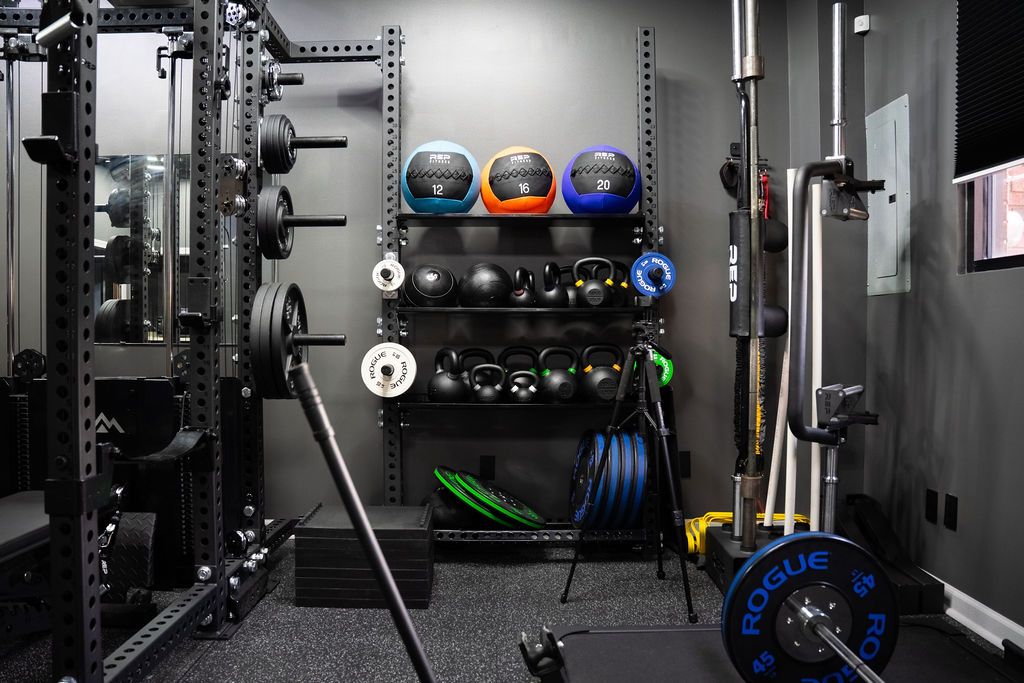 Inside the Licensed Performance facility — barbells, kettlebells, and plate storage built for real training, not show.